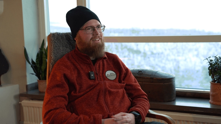 A portrait of Aril sitting inside during an interview