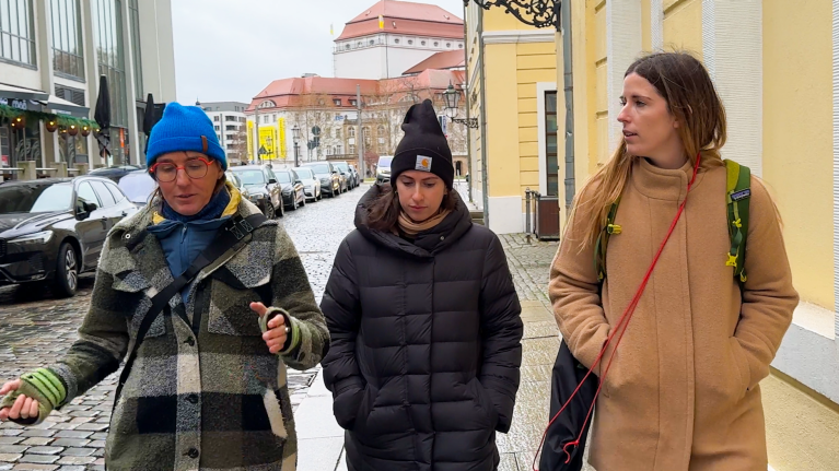 Anett, Shayna, and Rachel walk down a street in Dresden