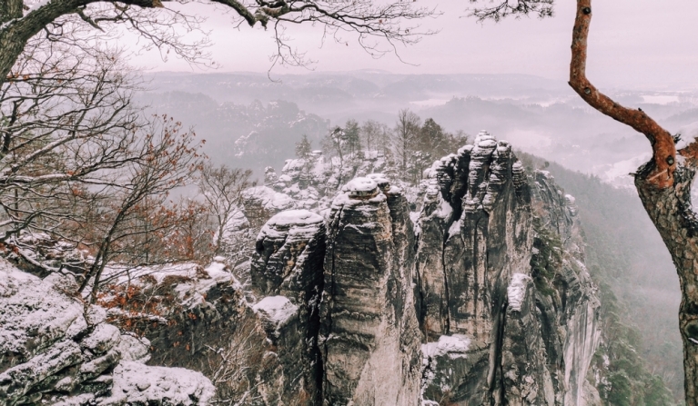 The cliffs and trees of Saxon Switzerland covered in snow