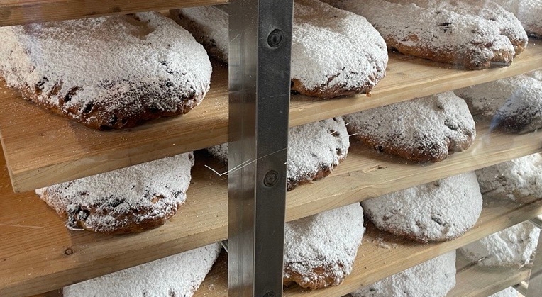 Freshly baked stollen cool on an outdoor rack in Dresden