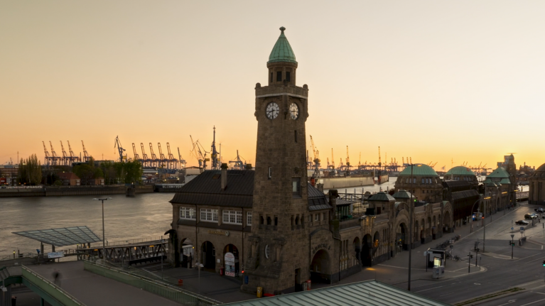 Sunset on the Elbe River, with Hamburg's market hall and docks 