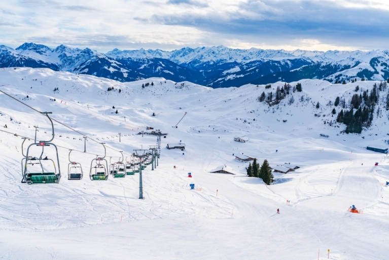 A chairlift with mountains in the distance in Kitzbuhel, Austria