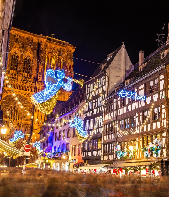 Light displays of angels strung between historic buildings in Strasbourg