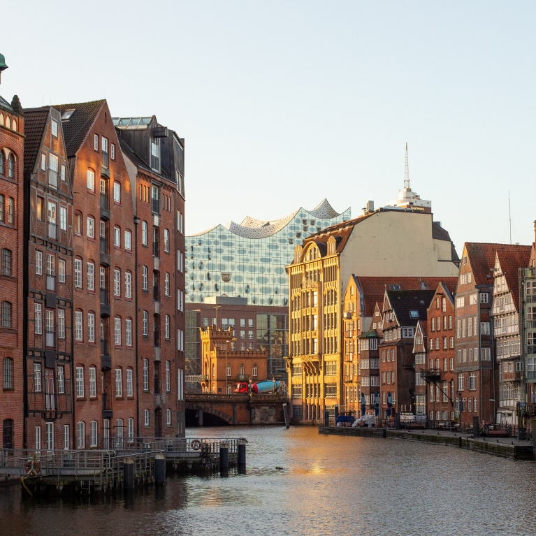 A bridge leads between two red-brick buildings