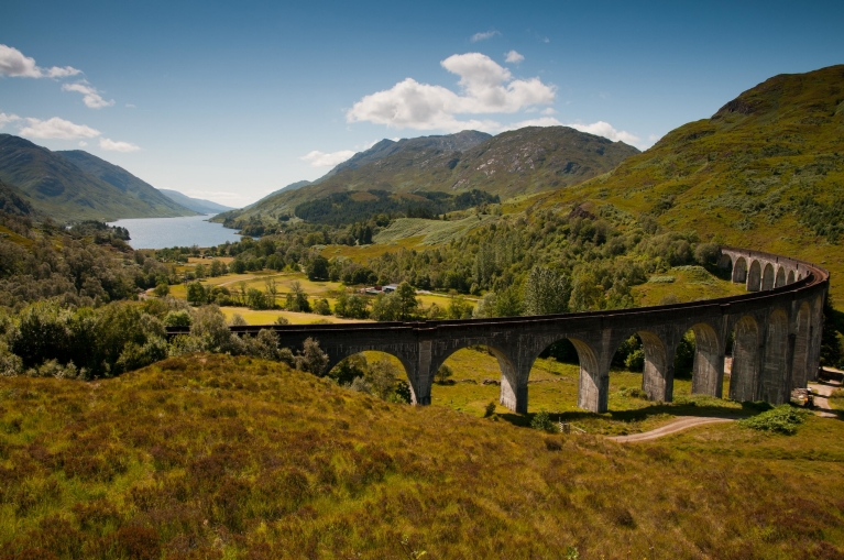 A bridge stretches across the green Scottish Highlands