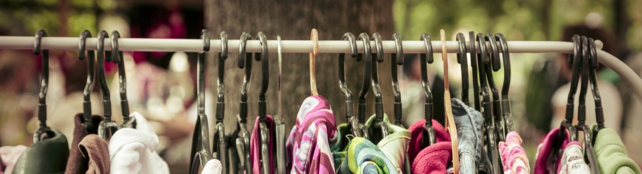 clothes on a rack on a flea market.