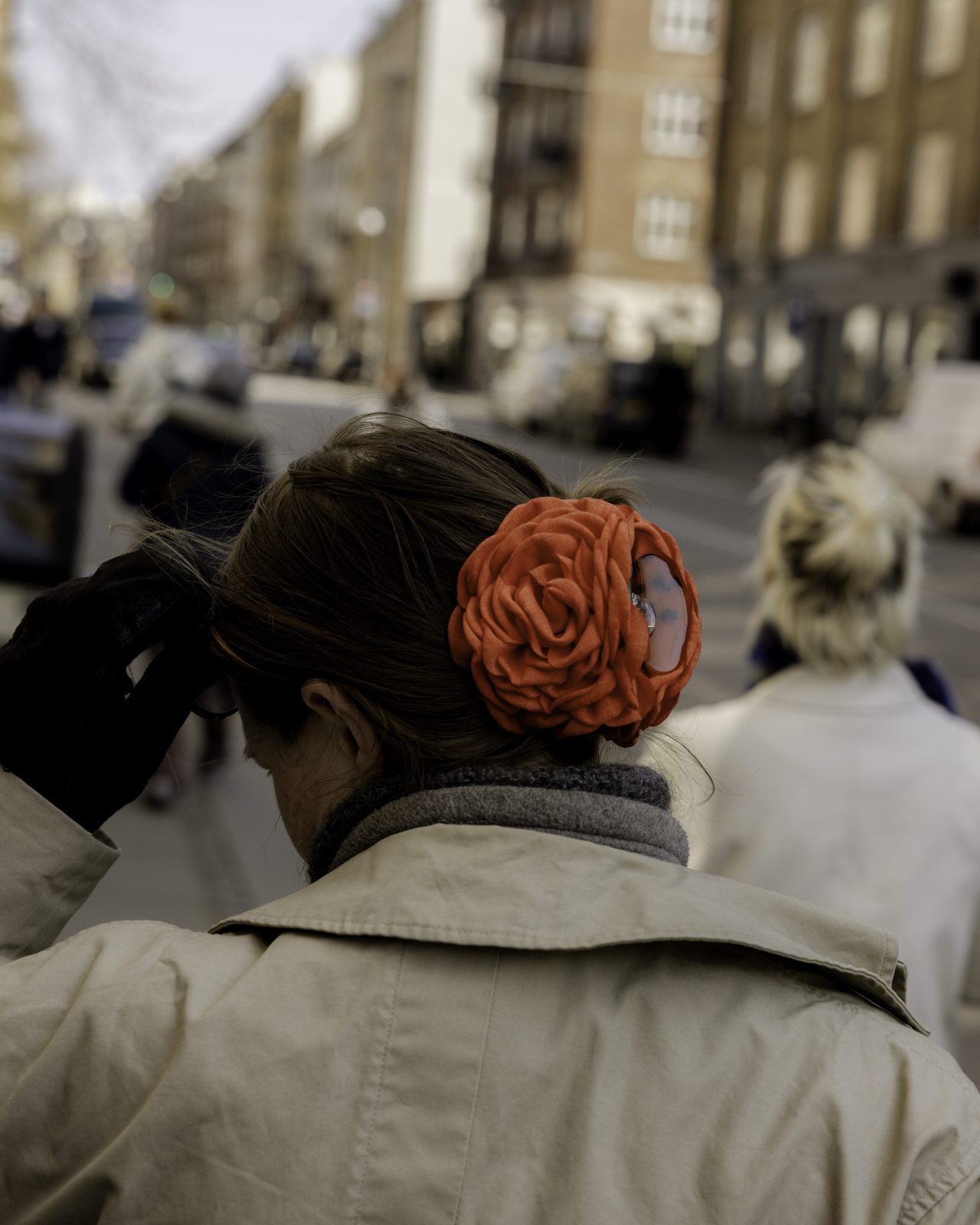 A woman with a red hair clip on a street in Copenhagen, Denmark