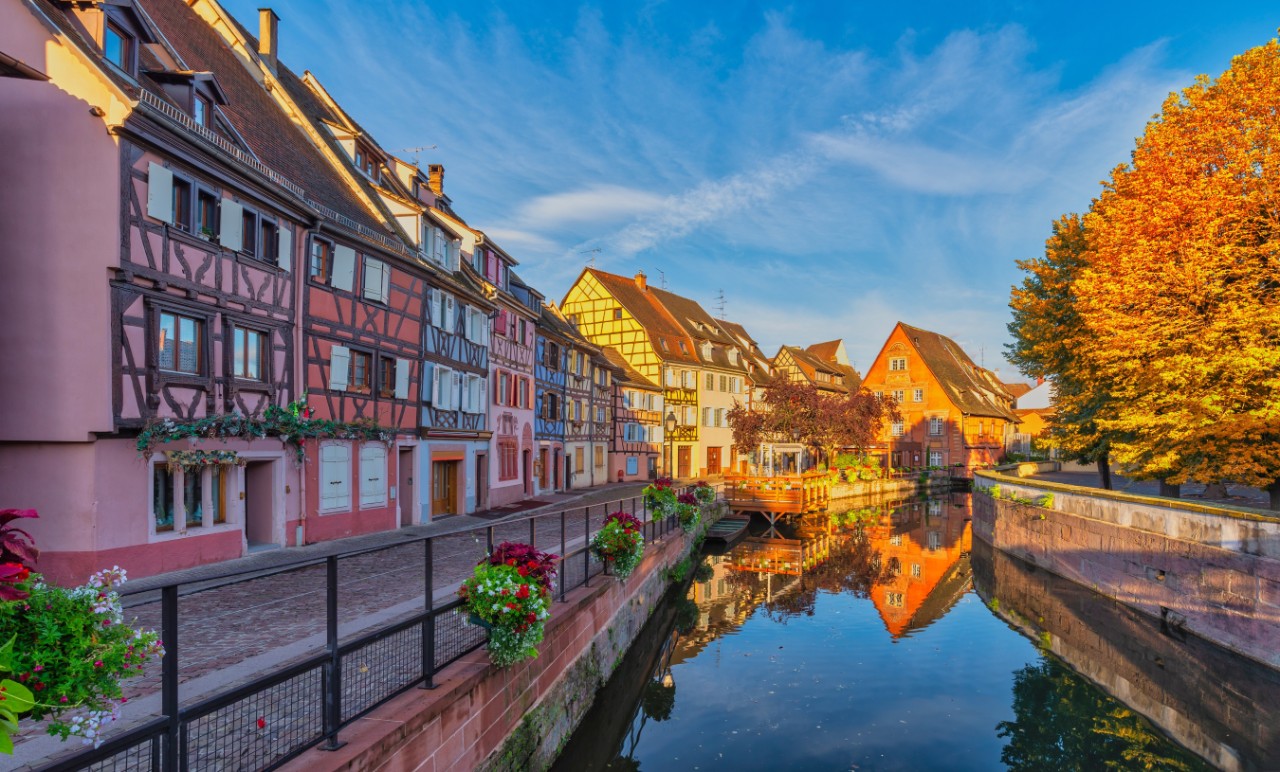 Colmar France, colorful half timber house city skyline at Ill River with autumn foliage season